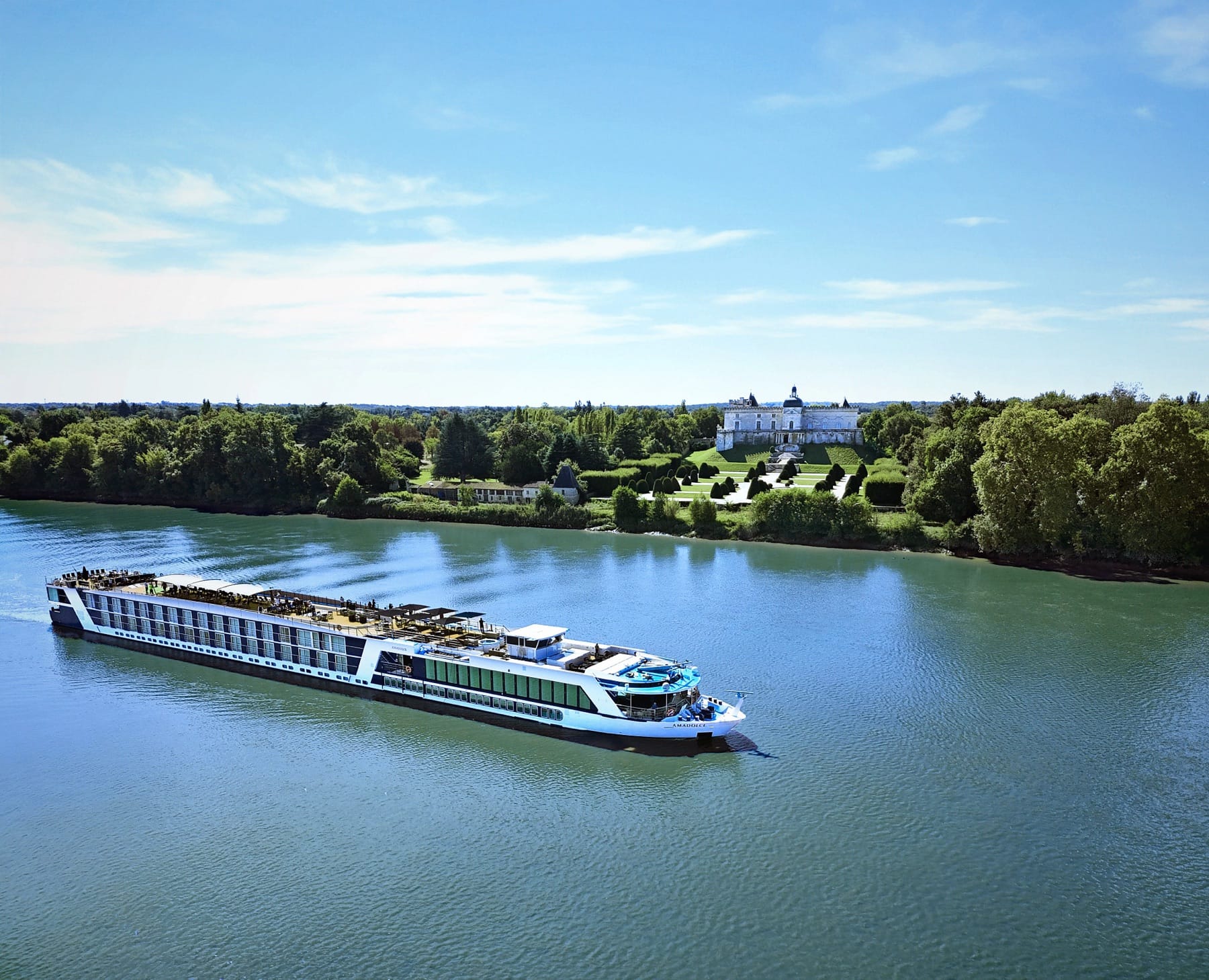 The AmaWaterways ship AmaDolce on the Garonne, a chateau and its gardens on the far bank near Bordeaux.