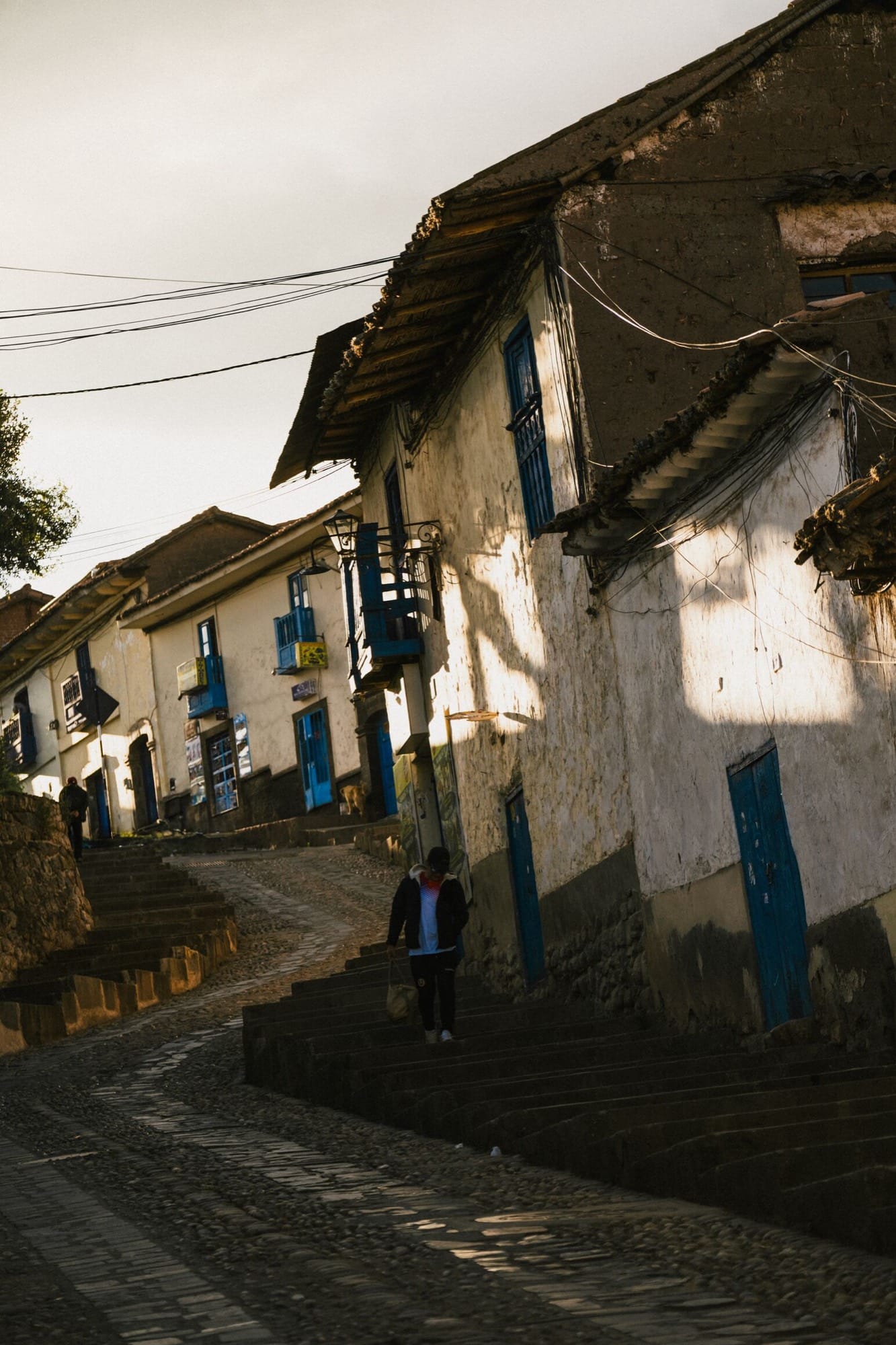 A Belmond property courtyard at Andean altitude — colonial stone, soft light, the high mountains close.