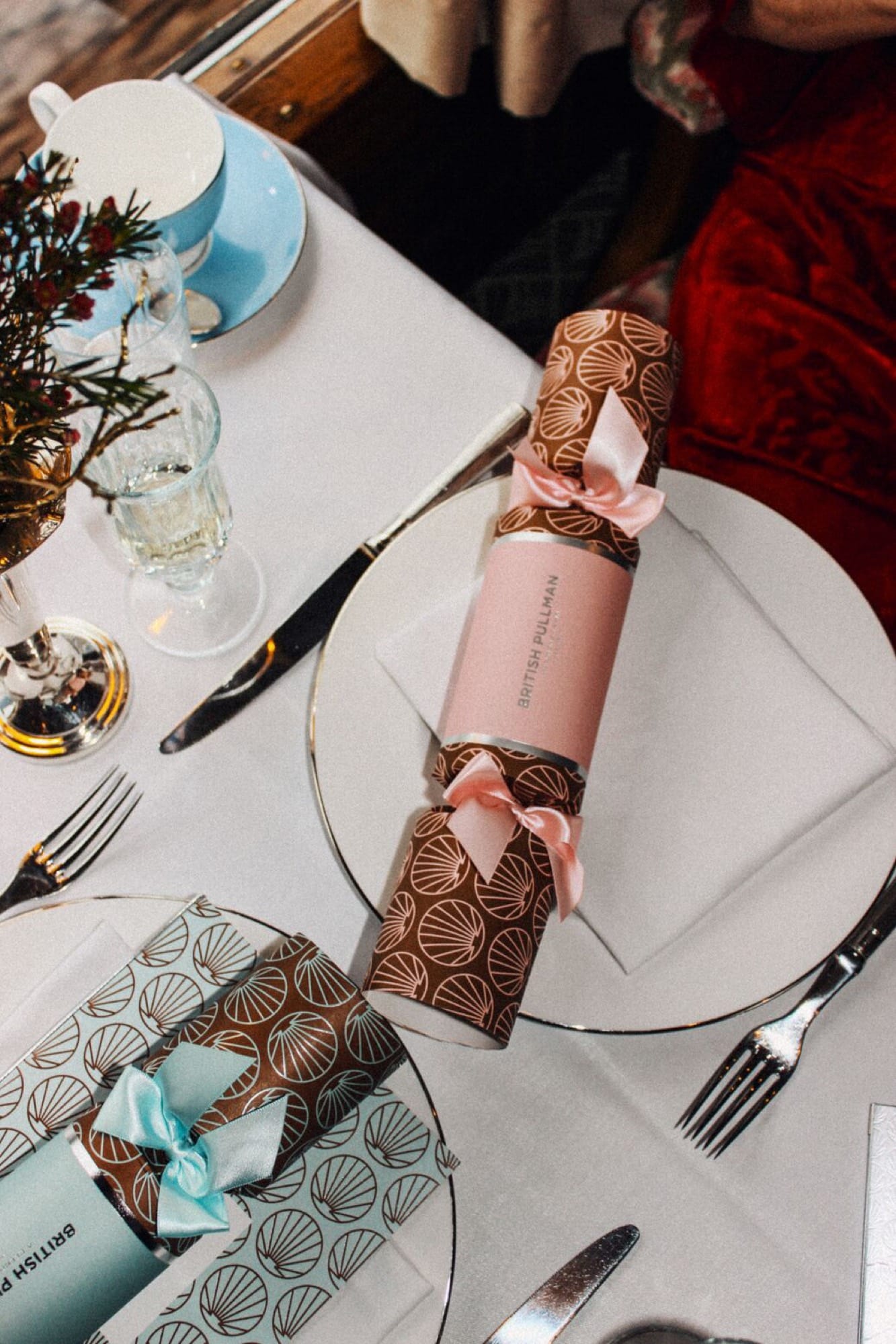 An evening interior aboard British Pullman — heritage lamps, marquetry, and the rhythm of a long English dinner service.