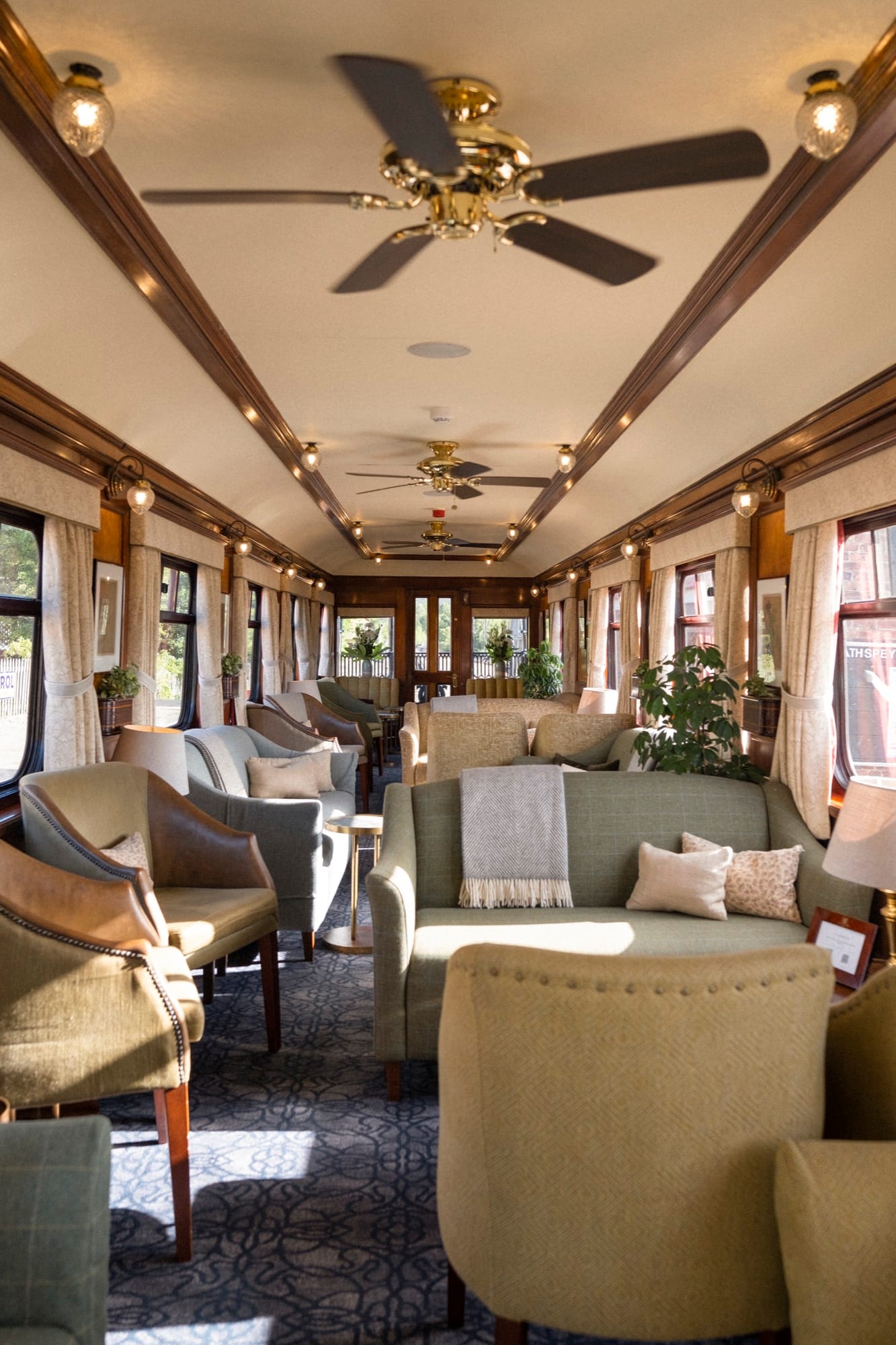 The Observation Bar aboard Royal Scotsman — drams, lamplight, and the heritage interior at rest.