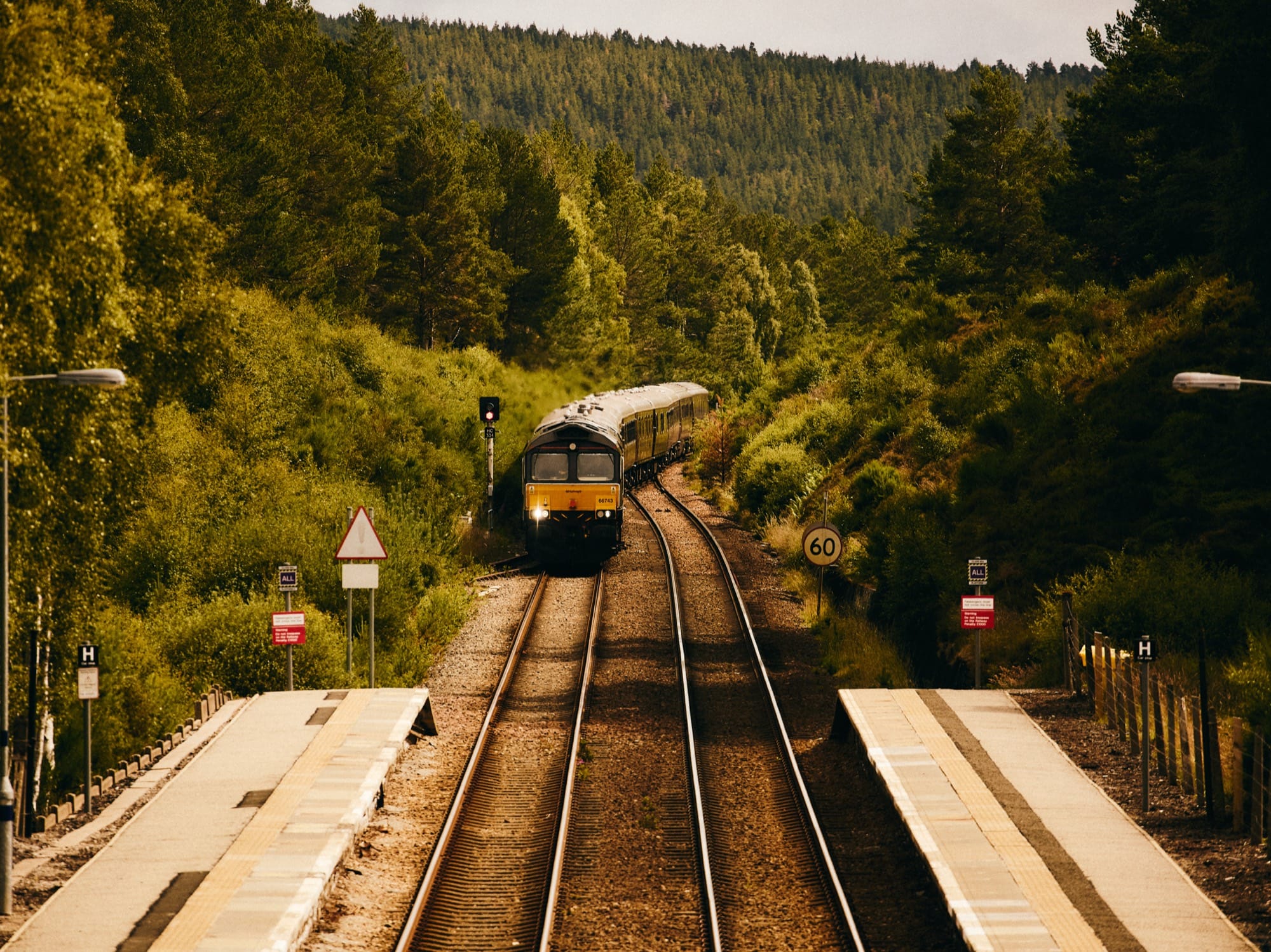 Royal Scotsman, A Belmond Train, in motion through the Scottish Highlands — heritage carriage exterior detail.