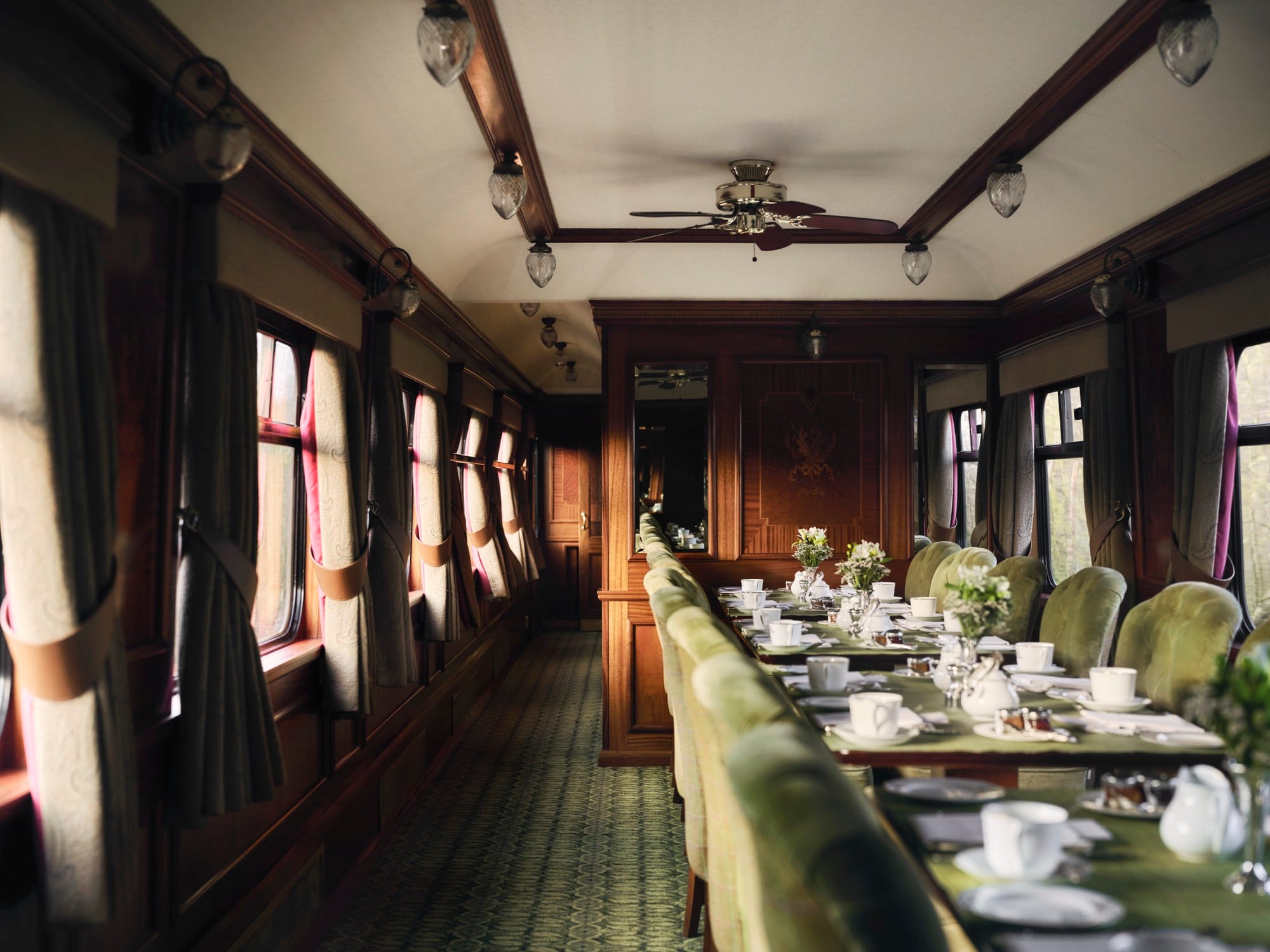 An Edwardian interior aboard Royal Scotsman — mahogany marquetry, tweeds, and the heritage detail that defines the train.