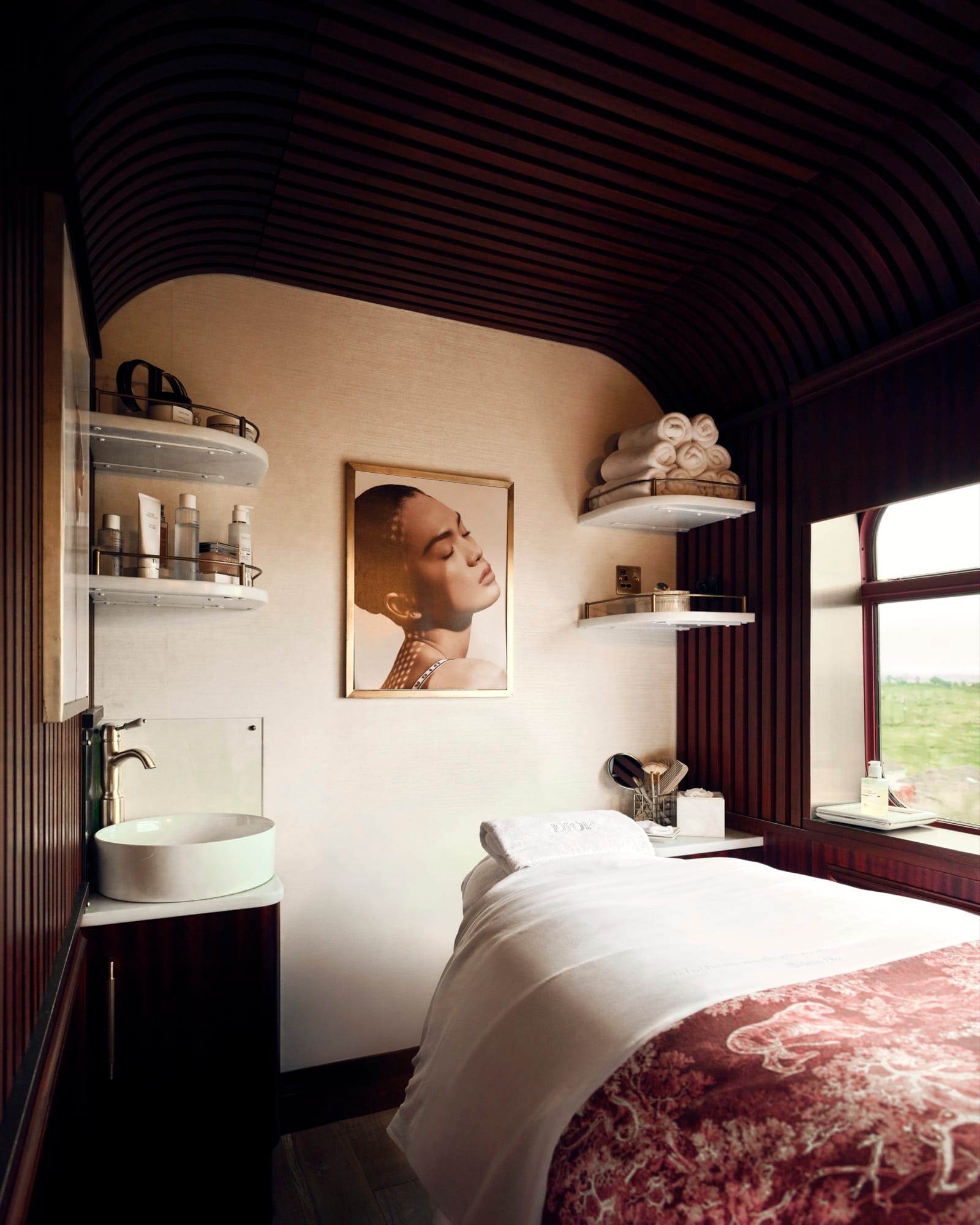 The Dior Spa carriage aboard Royal Scotsman — burgundy toile de Jouy lacquered treatment rooms in the Christian Dior register.
