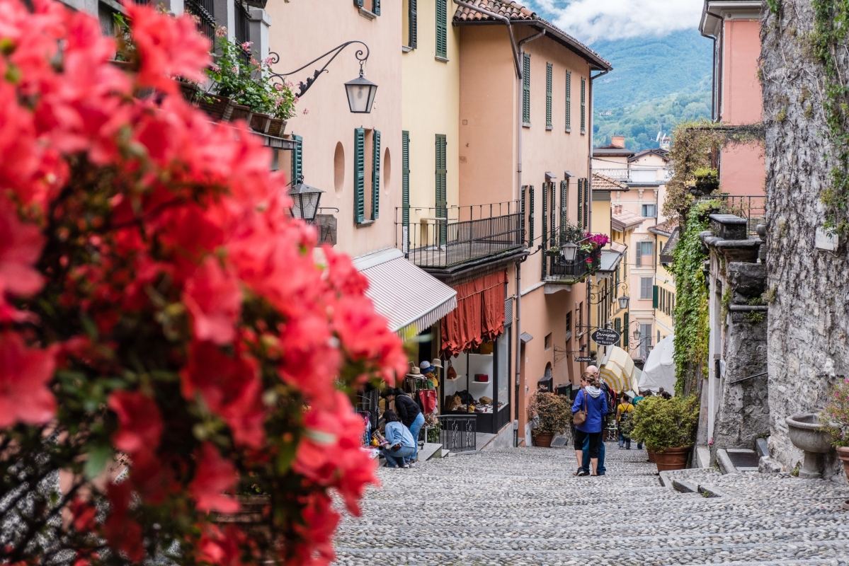 A lantern-lit lakeside street in Bellagio on Lake Como in the evening.