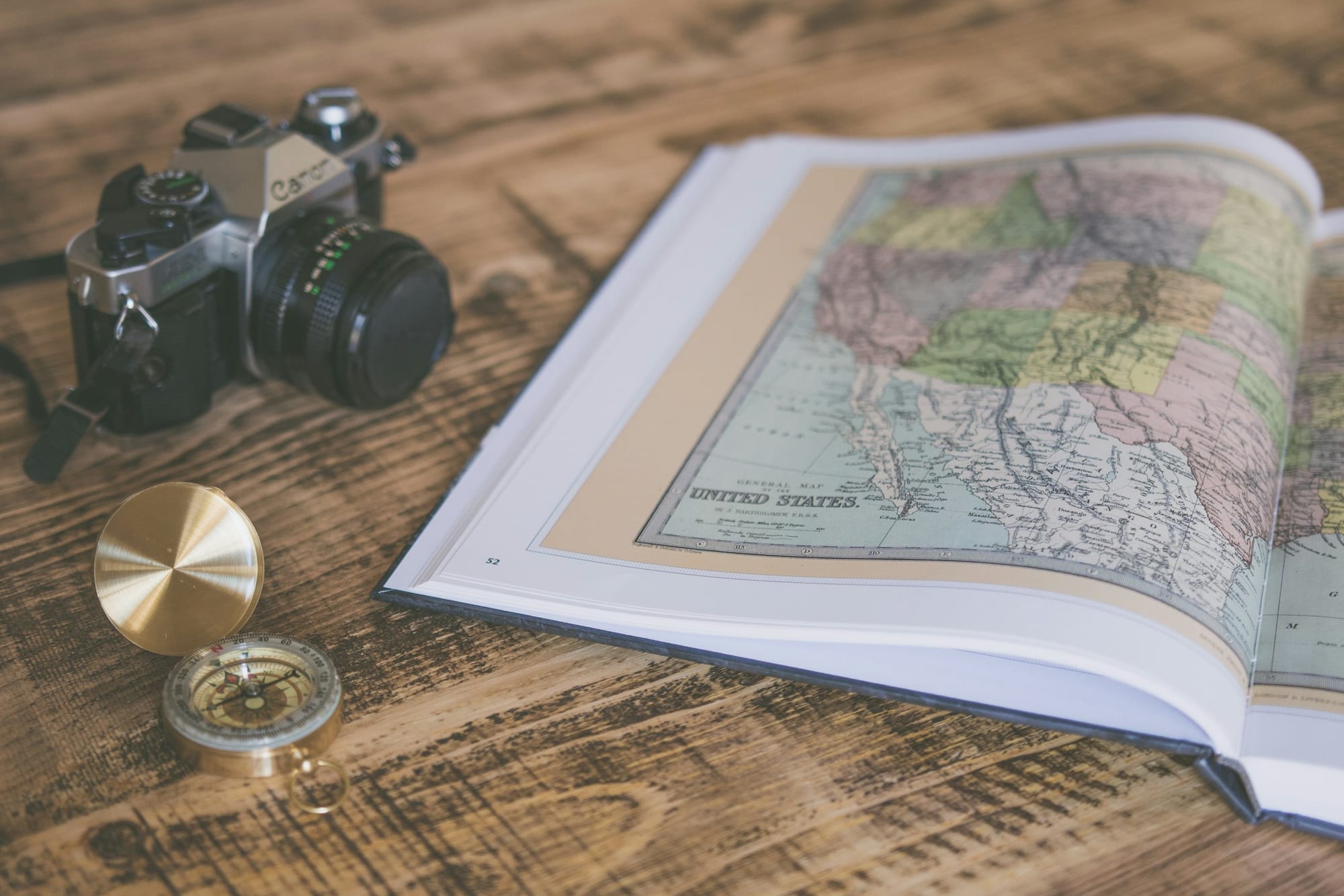 Vintage compass on a folded map.