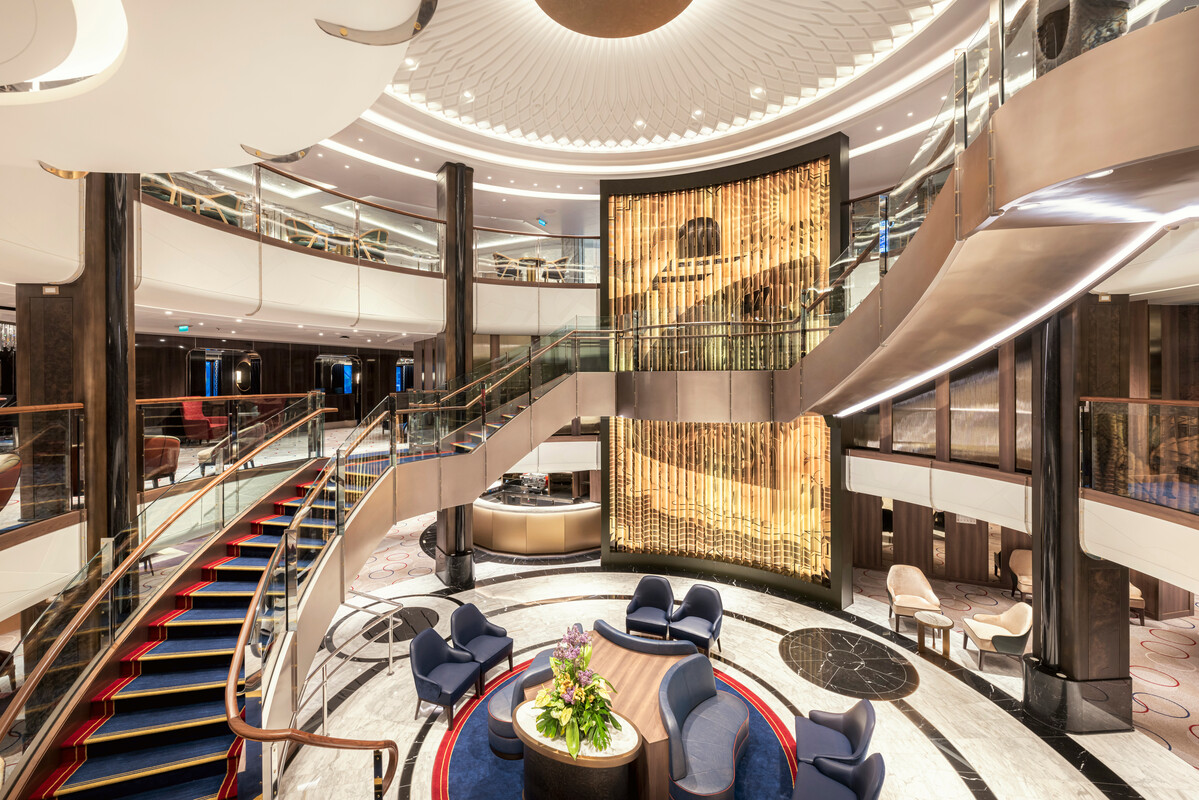 Queen Anne's Grand Lobby — the social crossroads rebuilt around a soaring commissioned artwork.
