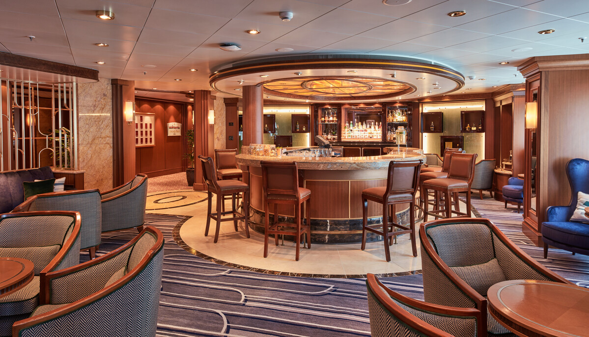 Queen Victoria's Chart Room — the maritime-brass cocktail lounge where a Gala evening begins.