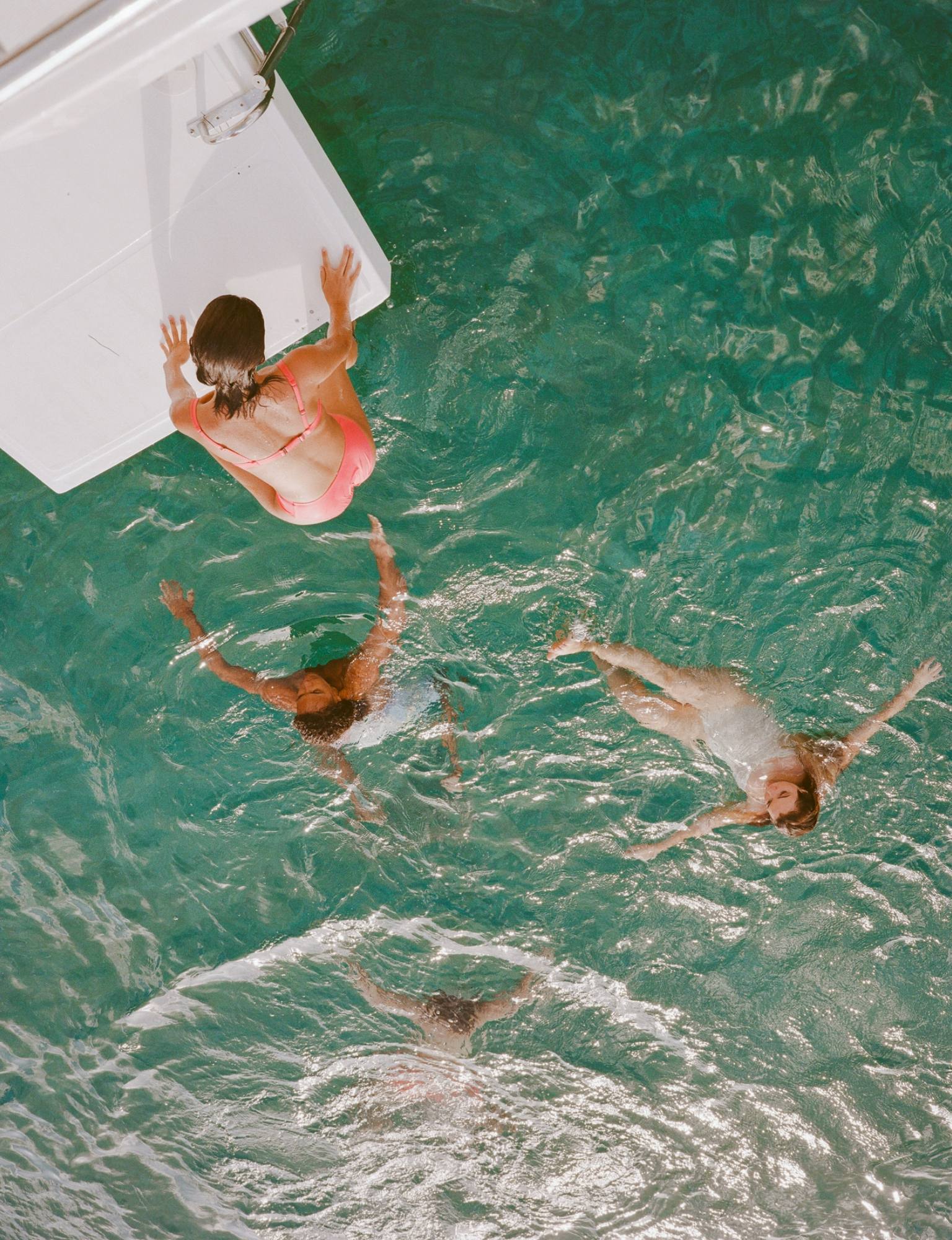 Two swimmers seen from above in the clear turquoise water at Cap Juluca.