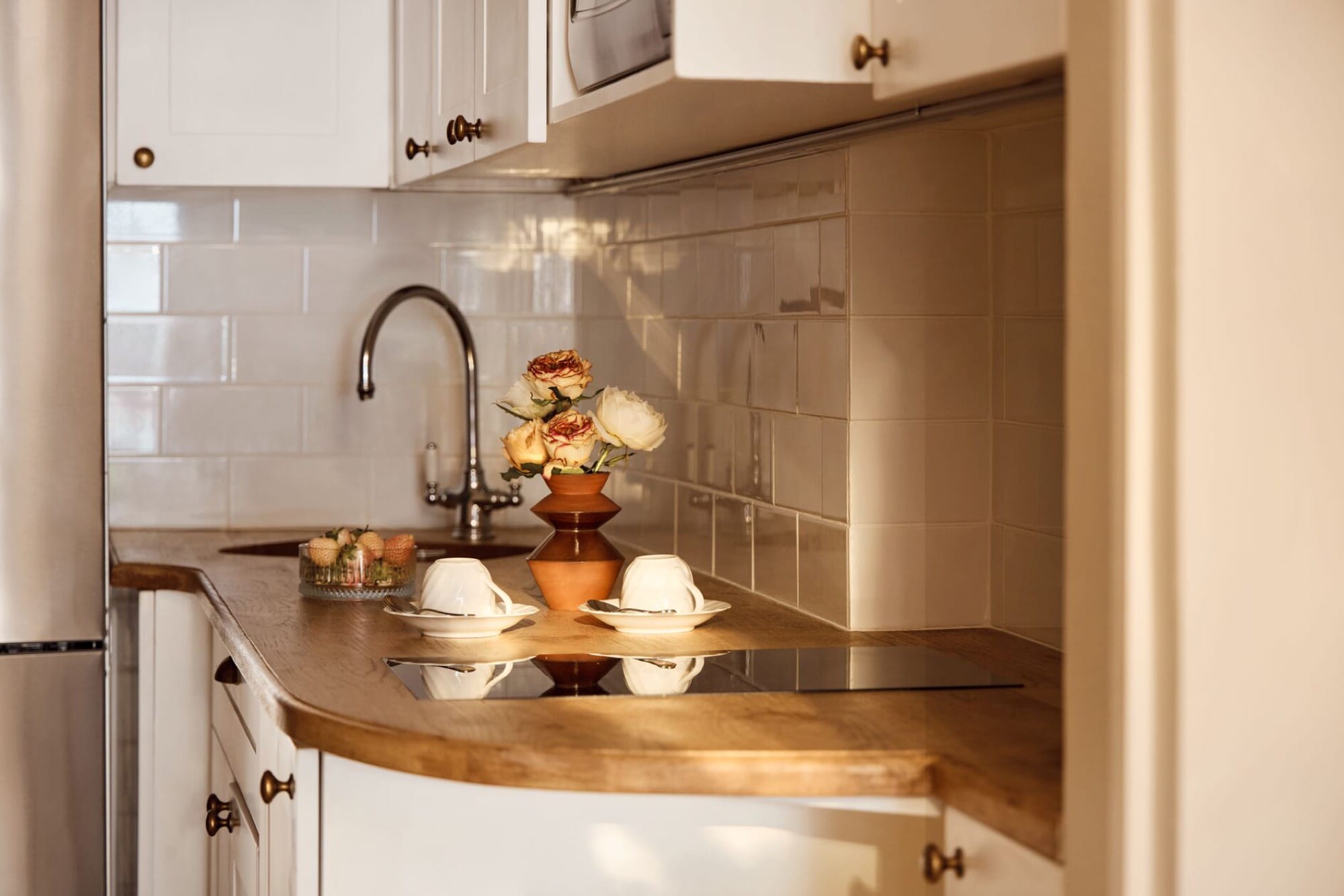 A Mount Nelson suite — pale palette, classical detailing, garden light through tall windows.