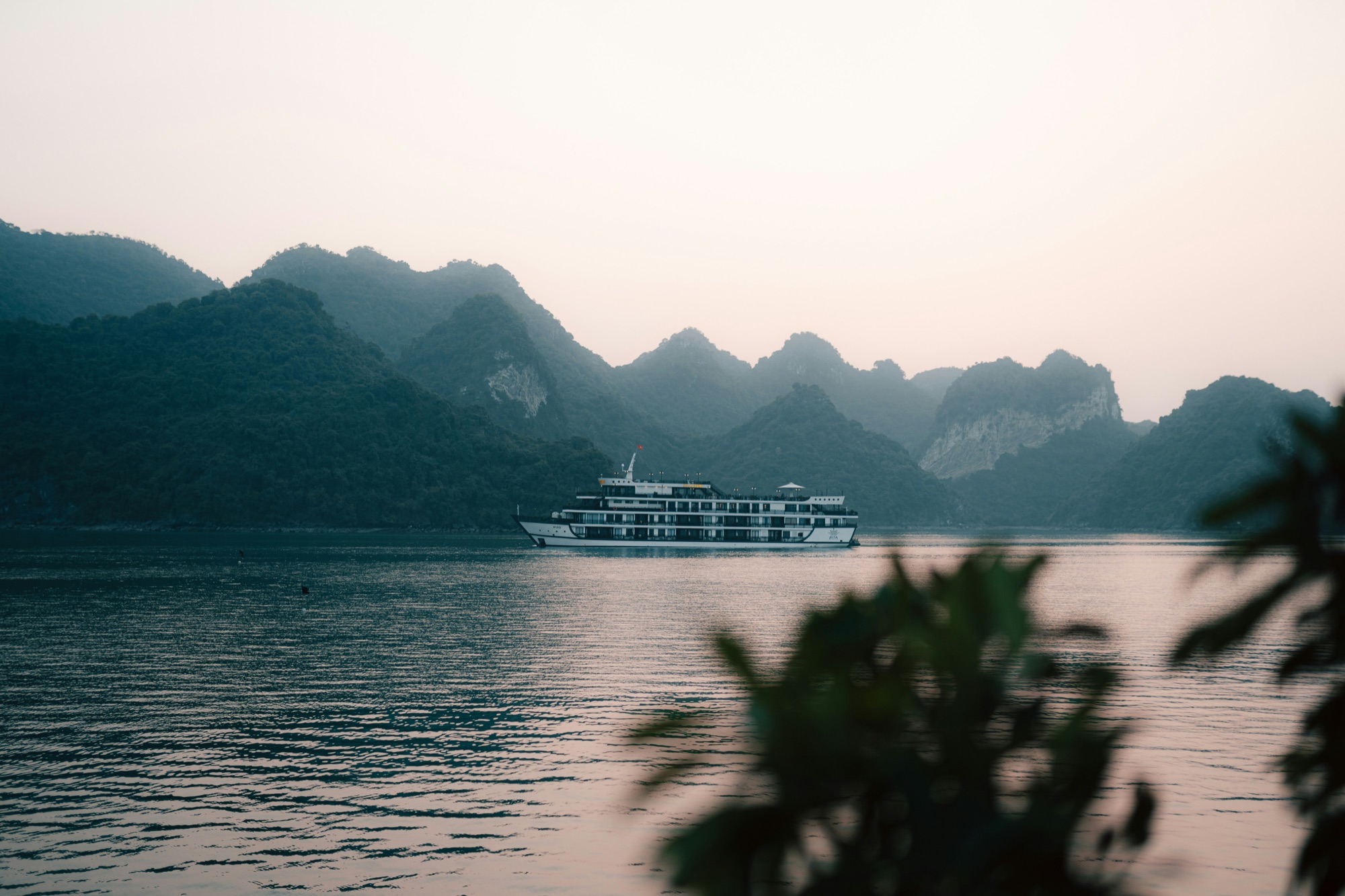 Traditional wooden junk boats among the limestone karsts of Halong Bay