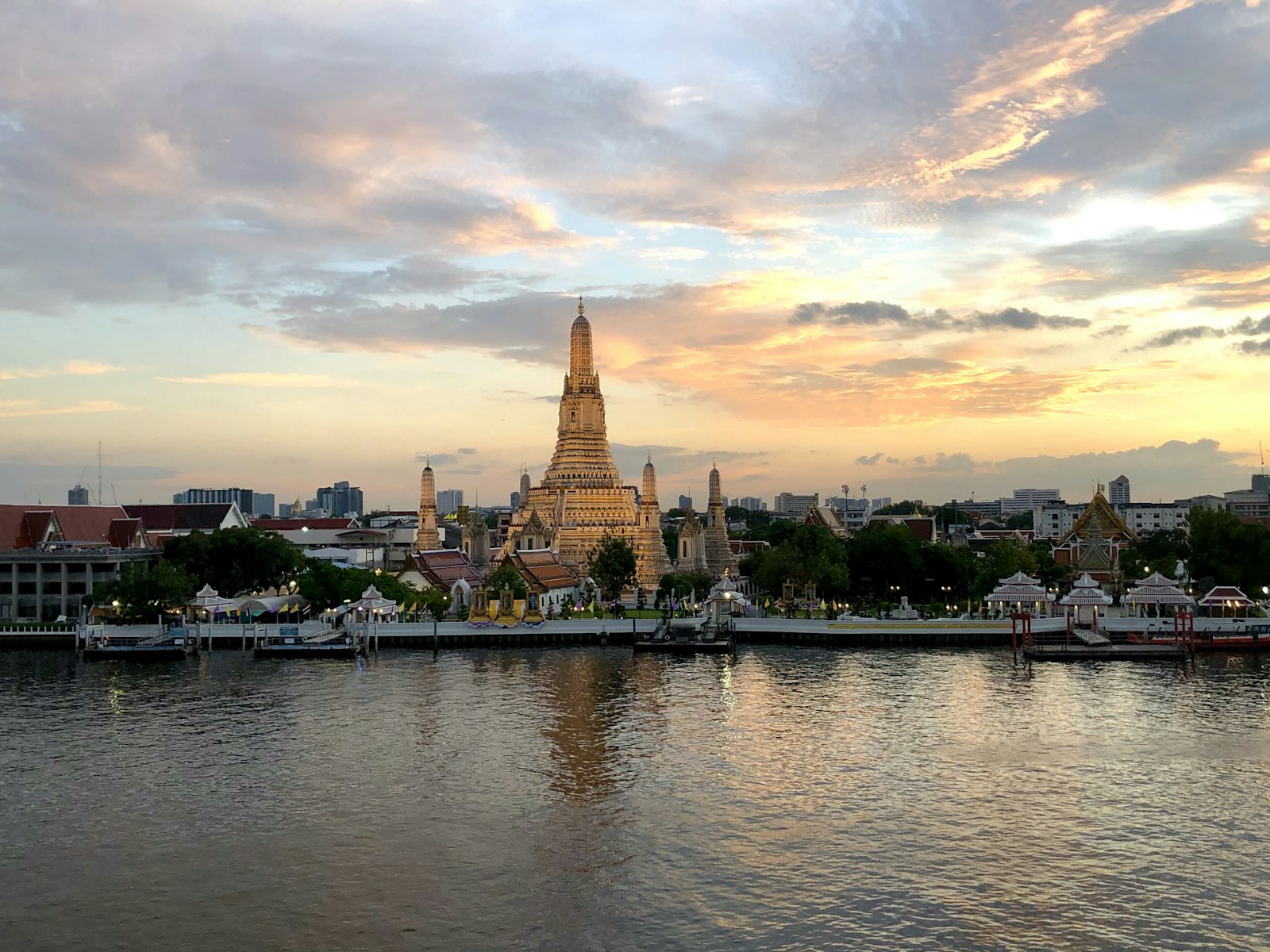 Thailand — Wat Arun at golden hour across the Chao Phraya River, Bangkok