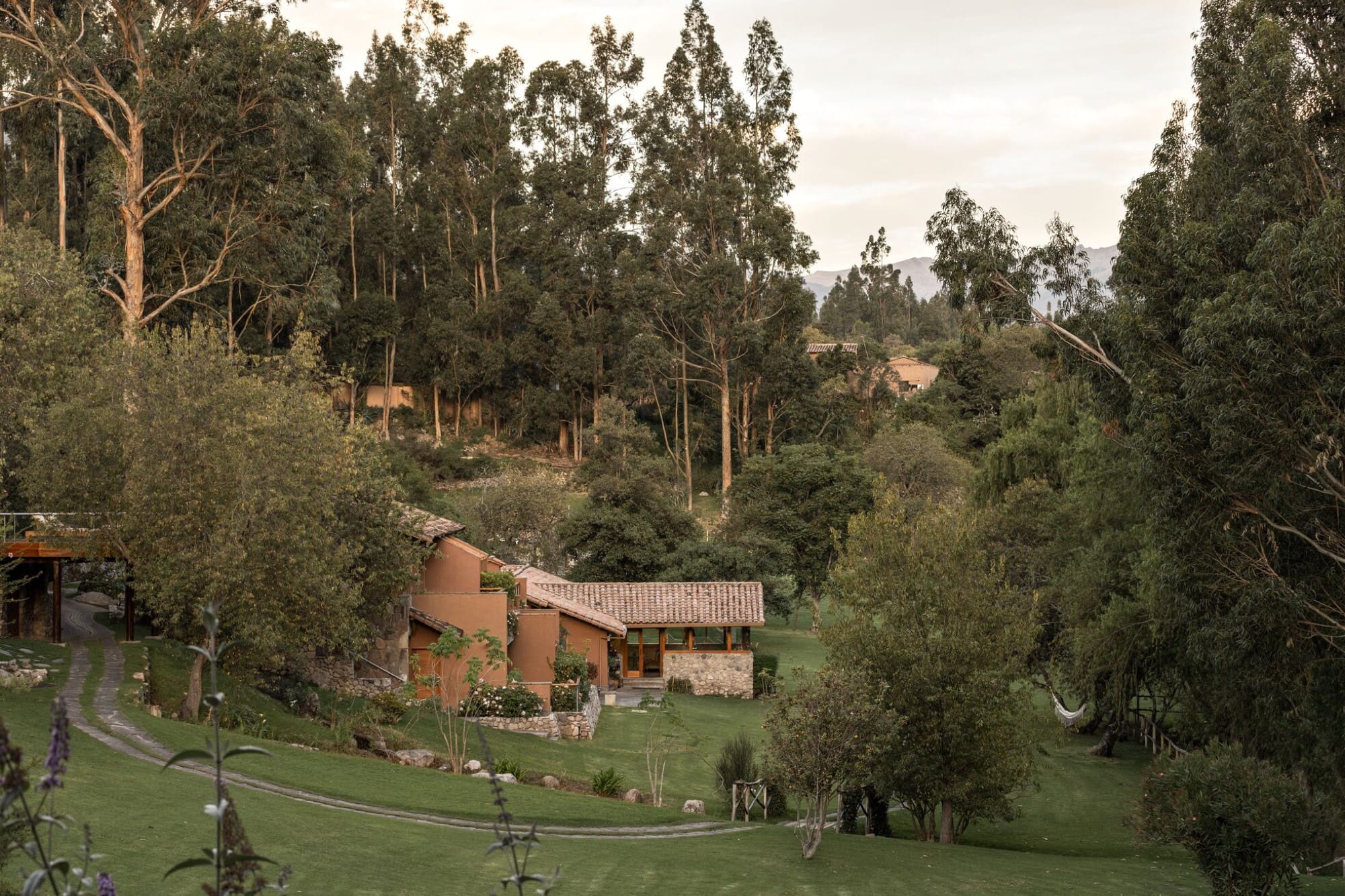 Evening at Rio Sagrado — the river, the casita lights, the Andes silhouettes overhead.