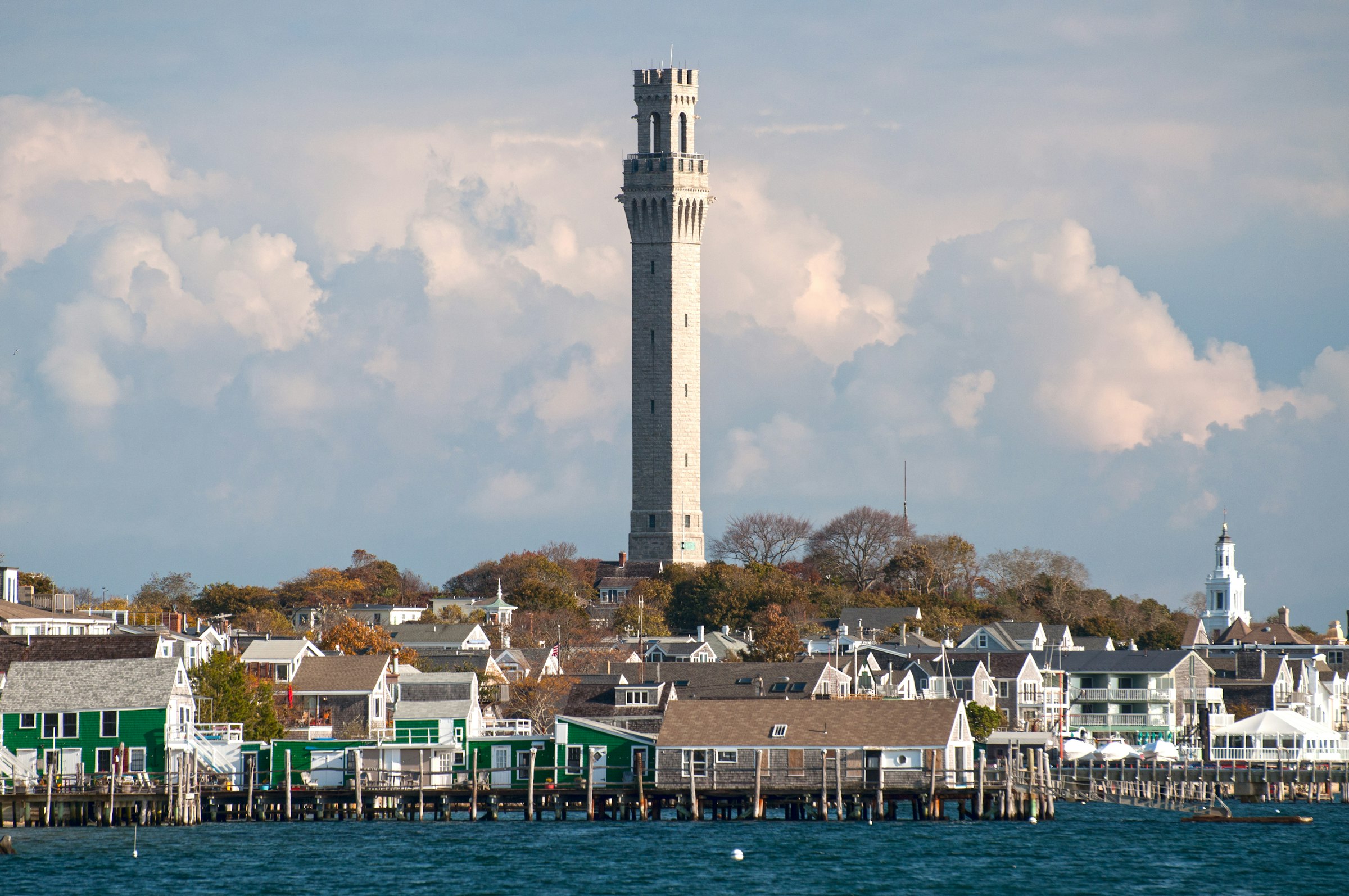 The Pilgrim Monument rising above Provincetown harbor and waterfront on Cape Cod, Massachusetts