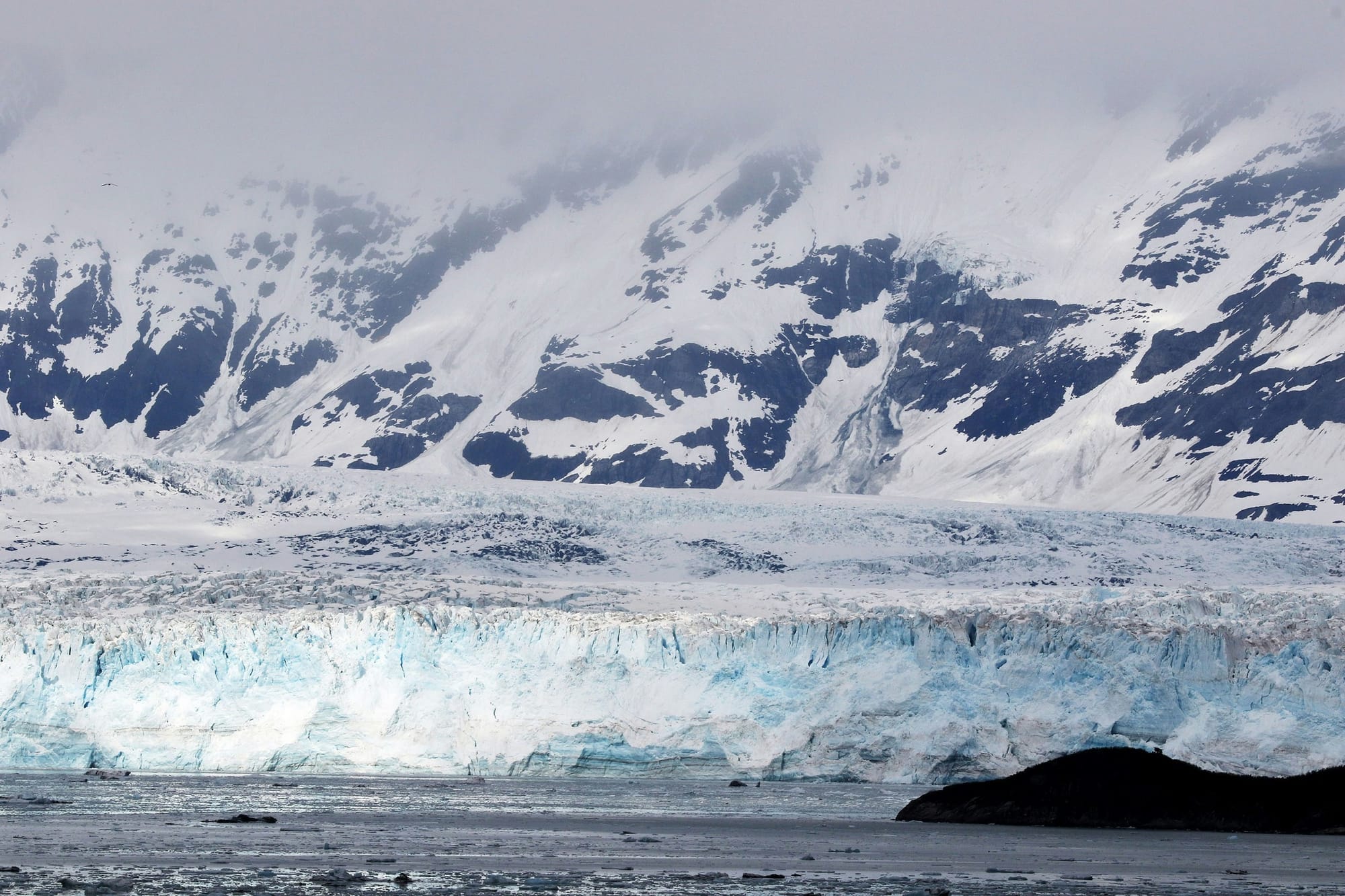 Tidewater glacier face above ice-strewn waters, Glacier Bay, Alaska