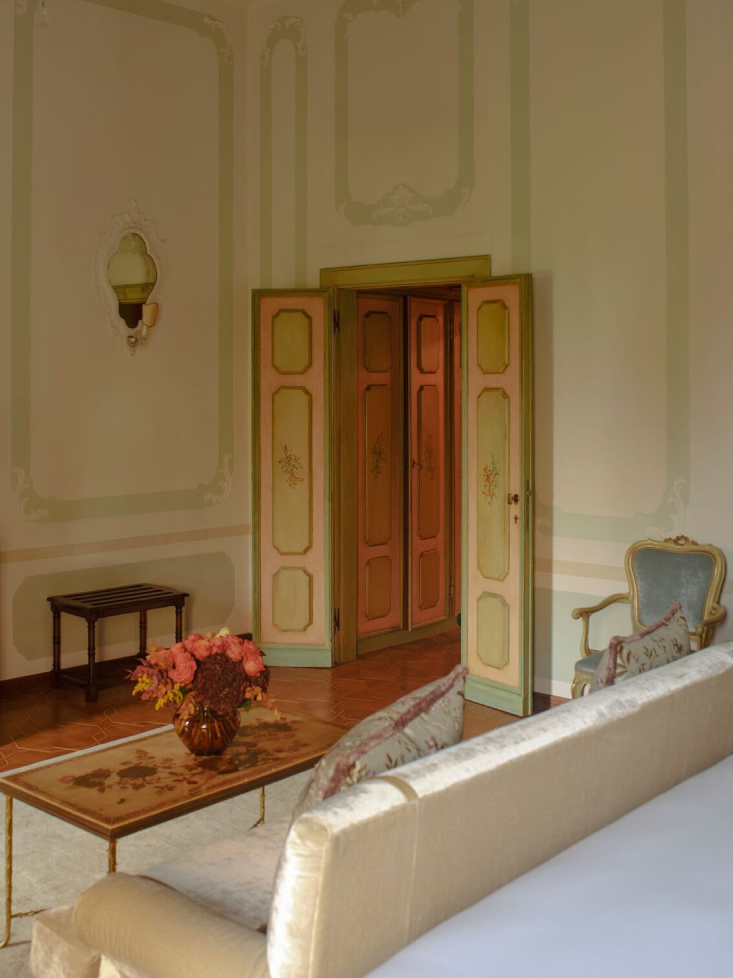 A Cipriani suite vanity area, evening light through arched windows.