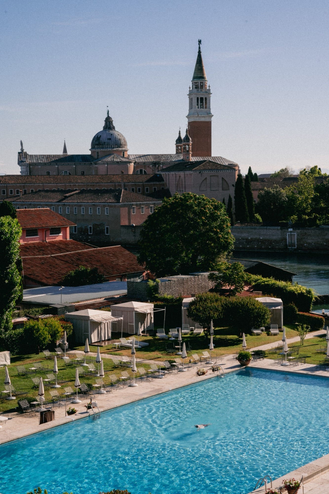 Hotel Cipriani's gardens, lagoon, and the silhouette of Venice across the water.
