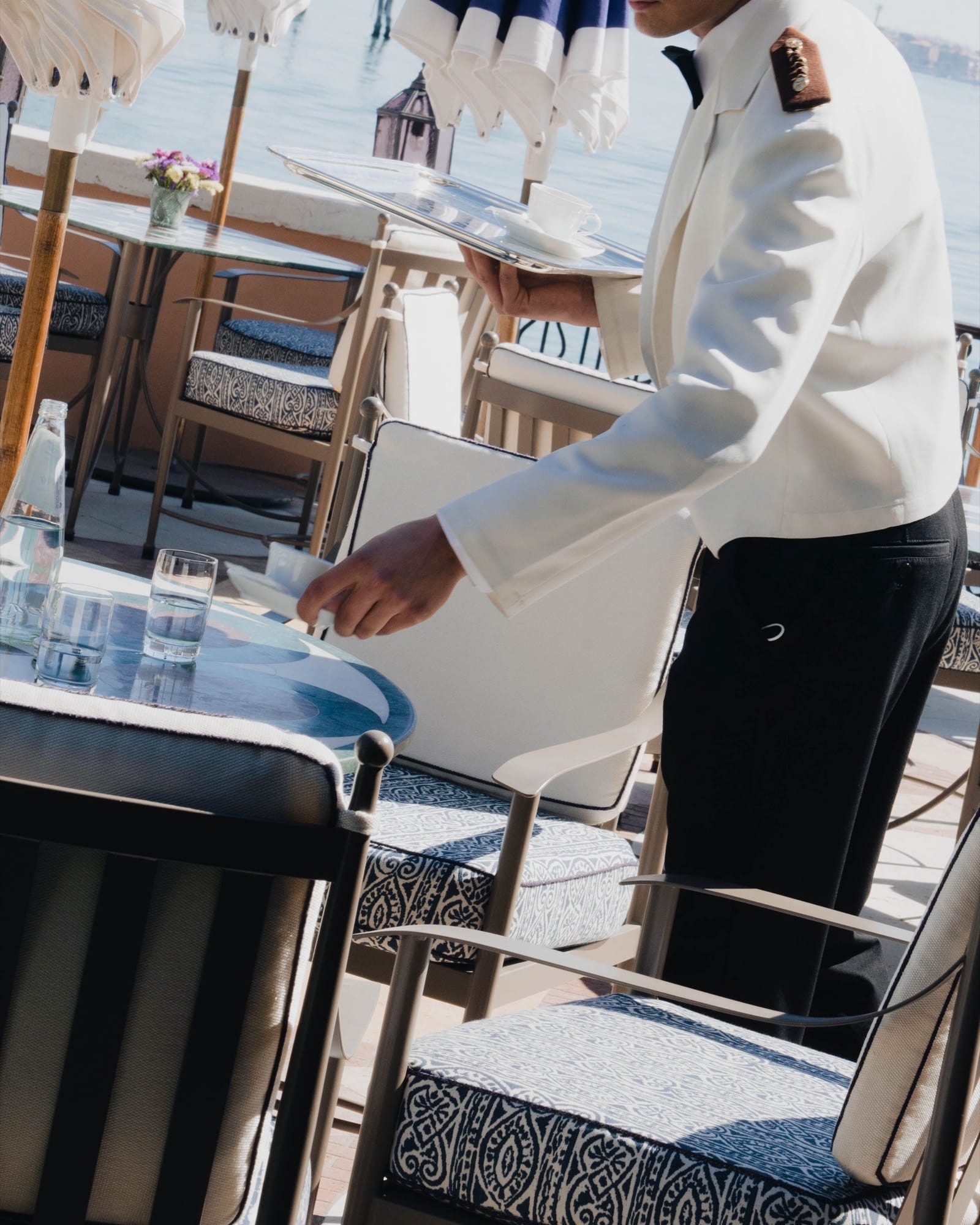 A long-serving Cipriani crew member at work — the kind of service that doesn't need to perform.