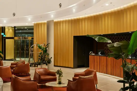 A warm, elegant hotel lobby with leather chairs and a reception desk — the relationship layer an advisor's work rests on.