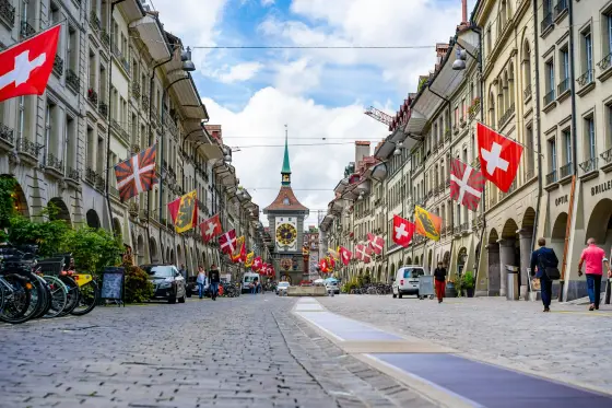 Medieval sandstone arcades and red rooftops along the Aare River in Bern, Switzerland