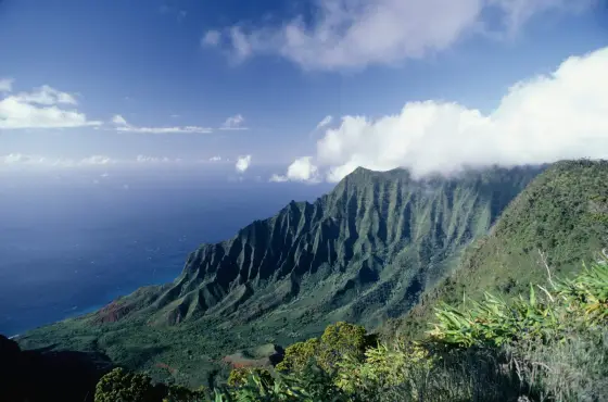 Lush green sea cliffs along the Na Pali coast of Kauai, Hawaii