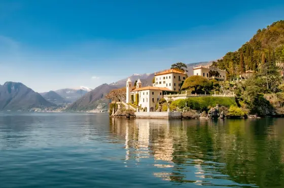 Villas and gardens along the shore of Lake Como beneath alpine foothills in Italy