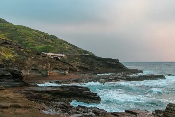Rugged red-earth coastline and clear ocean on the island of Lanai, Hawaii