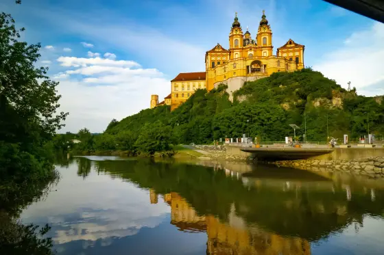 The baroque yellow facade of Melk Abbey above the Danube in Austria