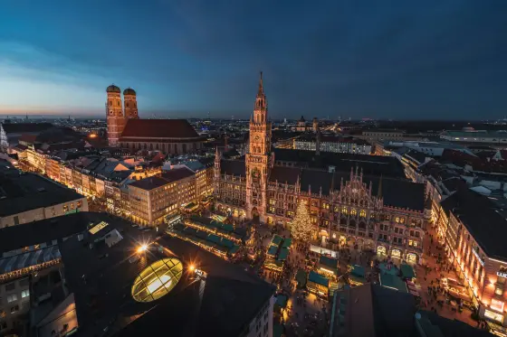 A historic square with ornate facades and church towers in Munich, Germany