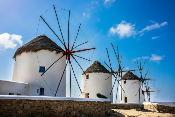 Whitewashed buildings and blue-domed churches above the Aegean Sea on Mykonos