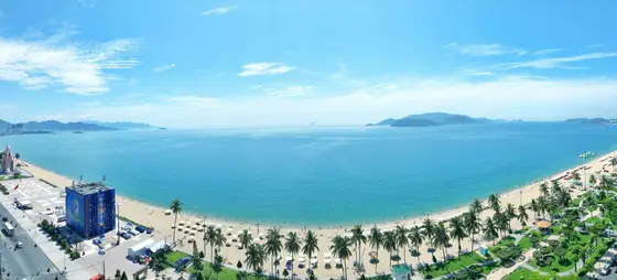 The sweeping turquoise bay and palm-lined beach of the Nha Trang coast, Vietnam