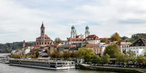 Pastel baroque buildings at the confluence of three rivers in Passau, Germany