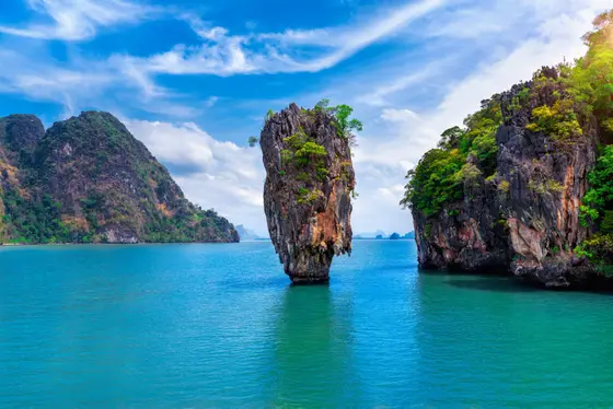 The limestone karst of James Bond Island rising from the emerald water of Phang Nga Bay near Phuket, Thailand