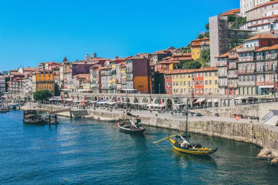 Colorful riverside houses and the Dom Luis I Bridge along the Douro in Porto, Portugal