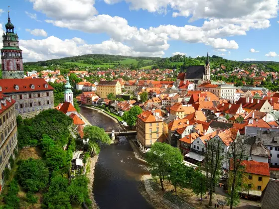 Red rooftops, spires, and the castle above the Vltava River in Prague