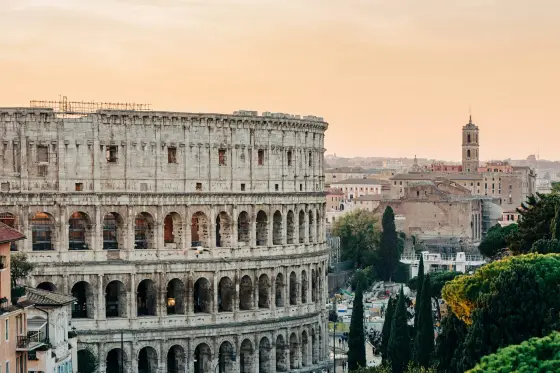 The ancient Colosseum standing among the ruins of Rome