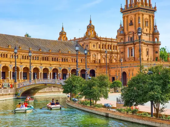 The ornate Plaza de Espana with its curved brick arcades in Seville, Spain