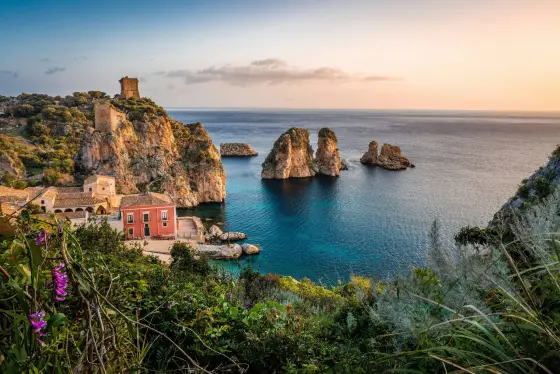 A coastal town with the sea and Mount Etna in the distance in Sicily, Italy