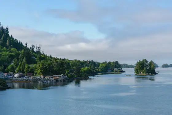 Forested islands and snow-capped mountains along the waterfront of Sitka, Alaska