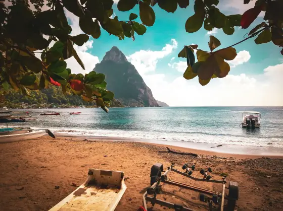 The forested volcanic Piton peaks rising from the sea on St. Lucia