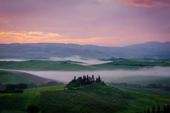 Cypress-lined roads winding through the rolling hills of Tuscany, Italy
