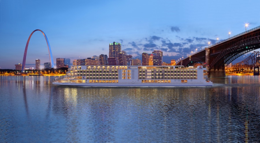 The Viking Mississippi moored at St. Louis in blue evening light, the Gateway Arch and the Eads Bridge behind her.