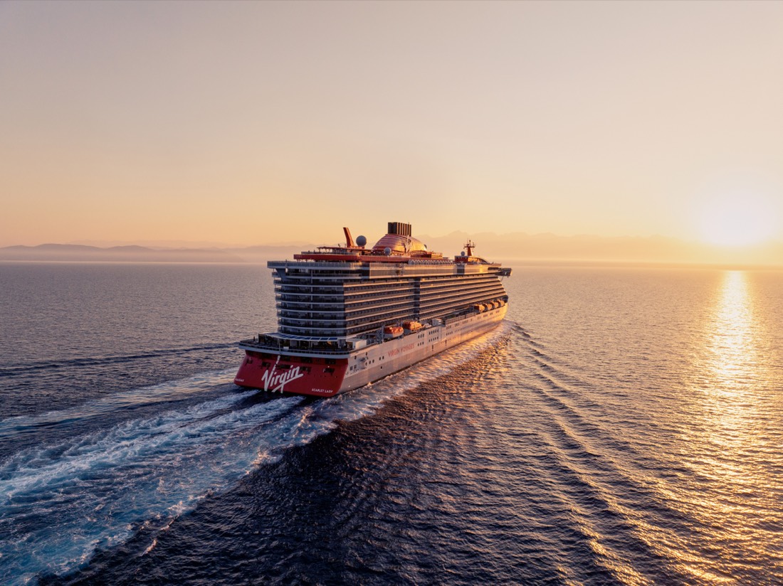 A Virgin Voyages ship under way on the open ocean.