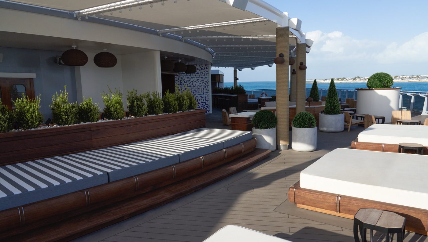 The Dock — white daybeds, potted olives, and the sea beyond, at the stern of a Virgin Voyages ship.