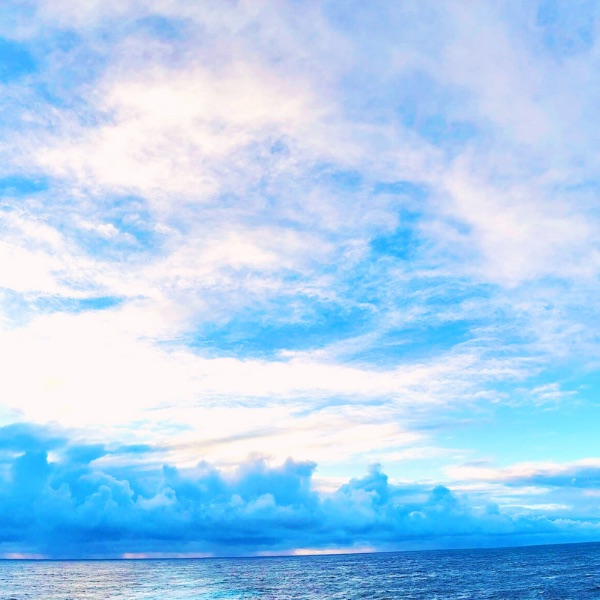 Cloud cover over open ocean meeting the horizon, mid-crossing.
