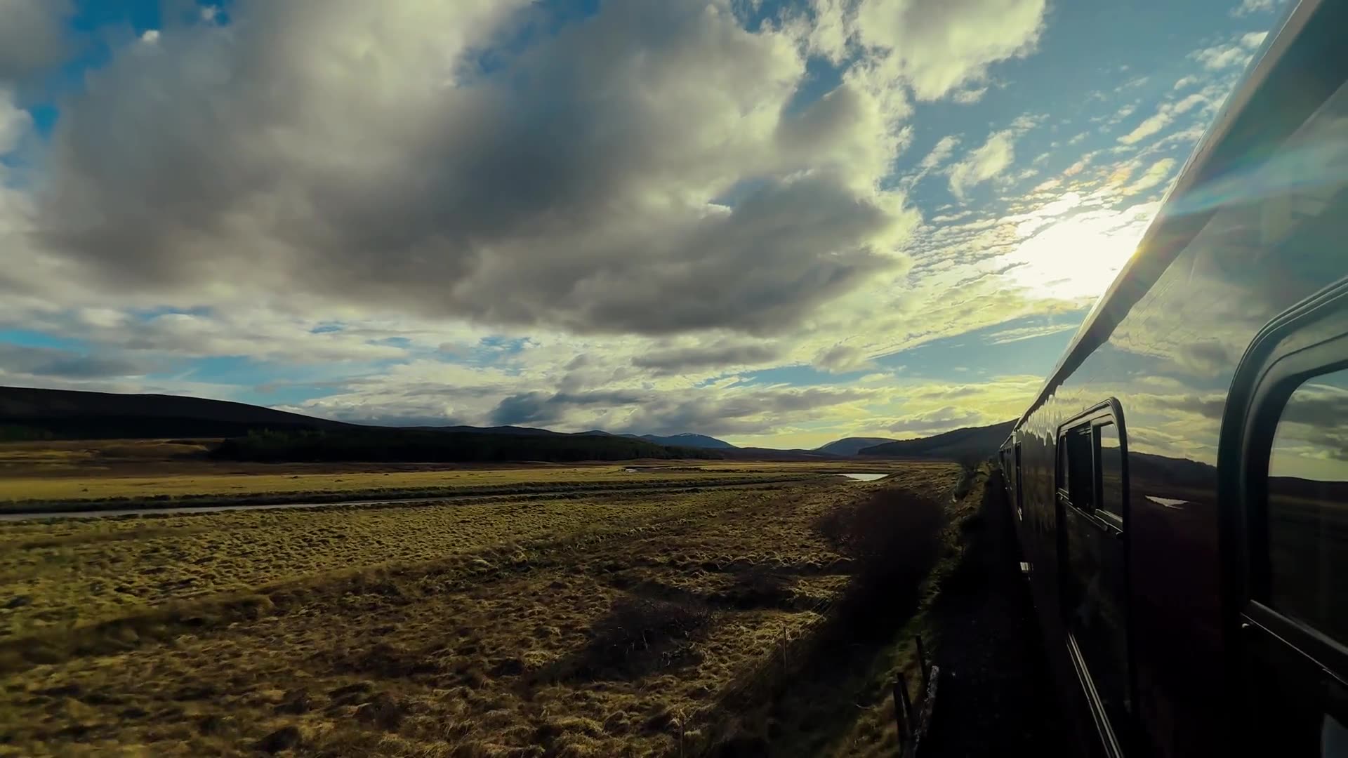 Royal Scotsman, A Belmond Train — curving along the rails through the Scottish Highlands at golden hour.